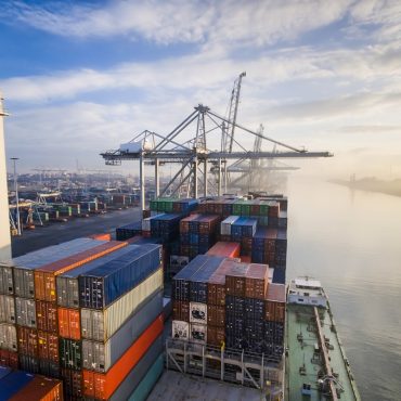 Sunrise in busy container terminal in Rotterdam, Netherlands.